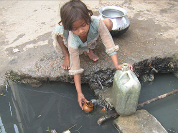 ... collects <b>drinking</b> <b>water</b> from a dirty public faucet in Bawana, <b>India</b>