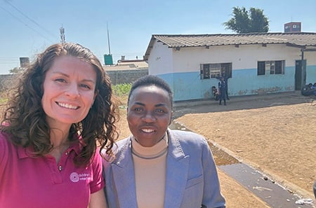 photo of two women outside a school in Lusaka, Zambia