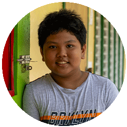 young boy leaning against green door