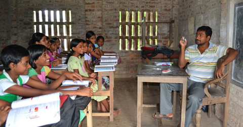 Kids in an Indian school listen as their teacher talks