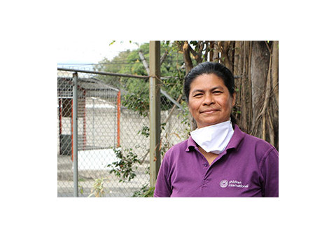 a woman standing outside of a house