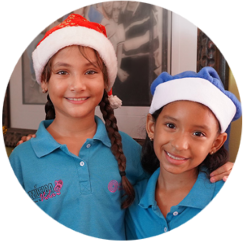 Sponsored kids wearing Santa hats smile