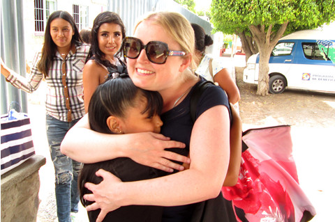 a woman hugging a young girl