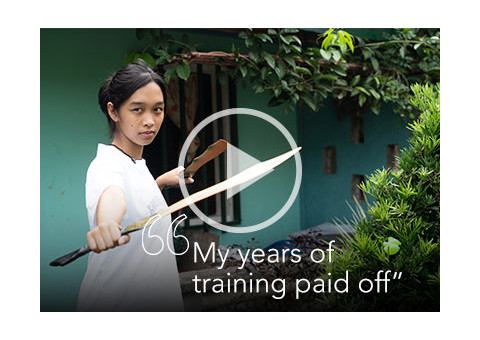 a young woman practicing arnis, a Filipino martial art