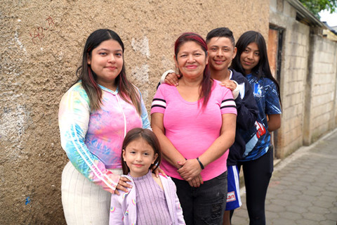 a family smiling to the camera