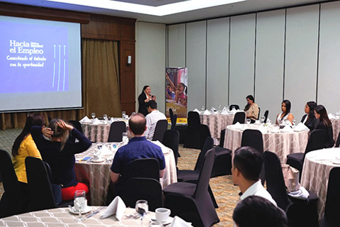 young adults in large room in training session
