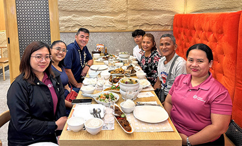 group of people around a table at a restaurant
