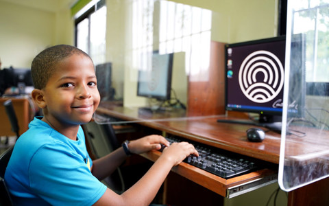 a boy using a computer
