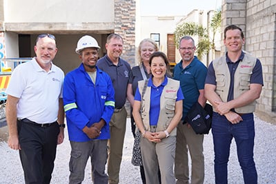 man in hard hat with group of leaders