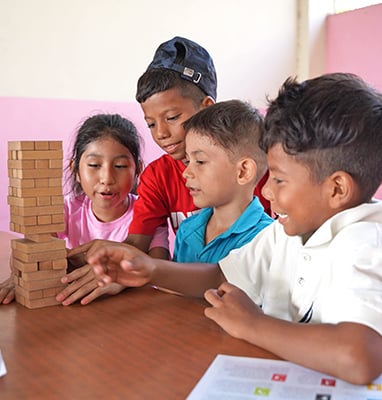 group of kids playing Jenga