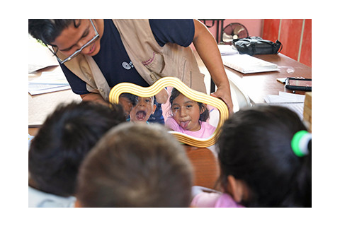 group of young kids looking in a mirror