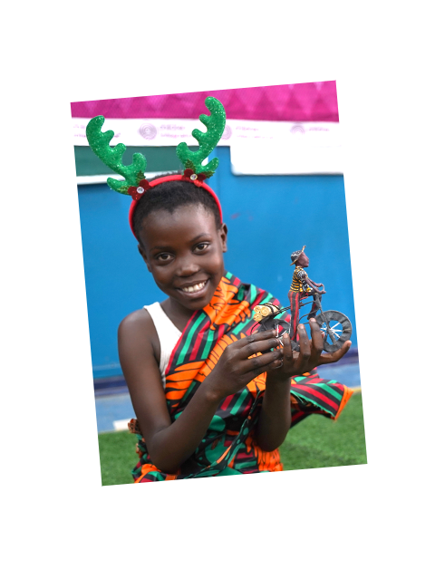 A sponsored child in Zambia with a toy