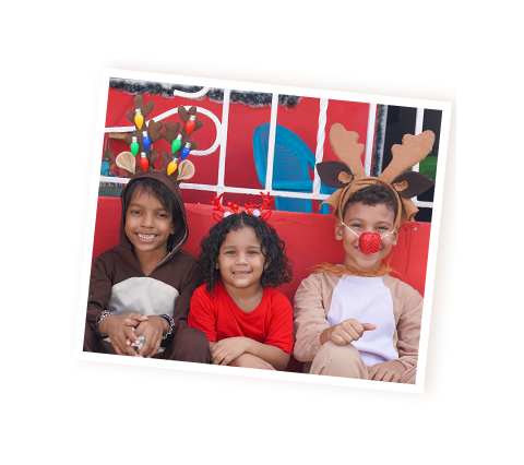 Children in holiday costumes smile