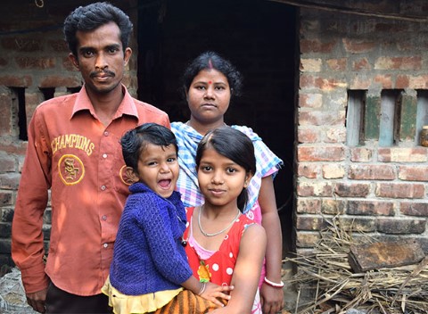a group of people standing in front of a brick building