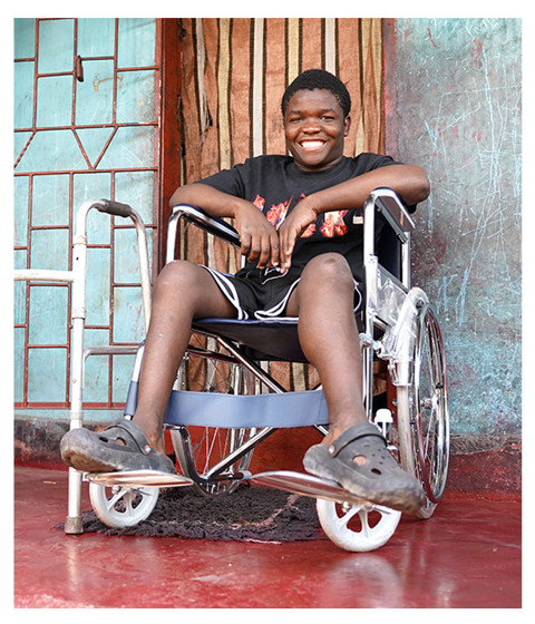a young boy sitting in a wheelchair