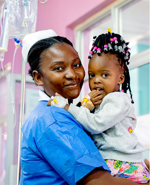 a nurse holding a little girl