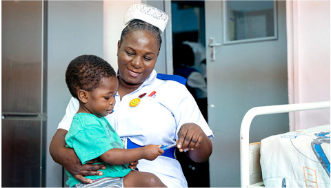 a nurse holding a little boy