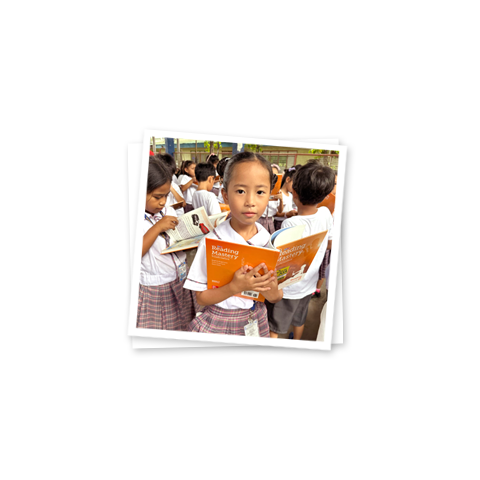 a young girl holding a book