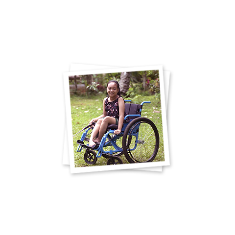 a girl in a wheelchair smiling