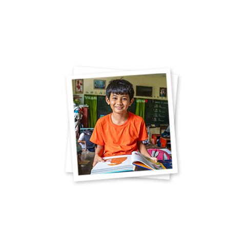a young boy holding a book