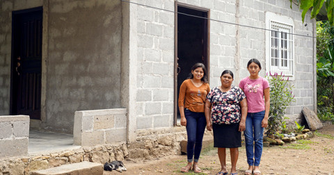 a family standing outside of their home
