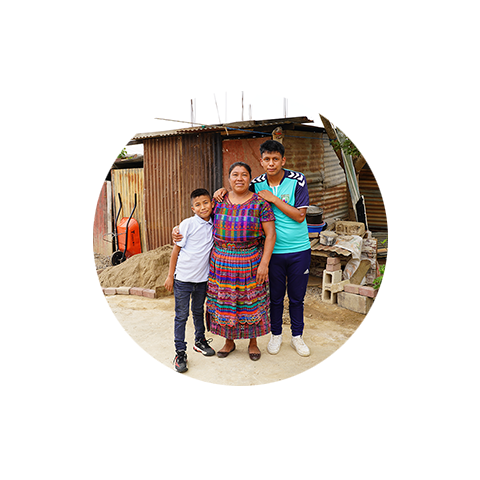 a woman hugging two boys in their house