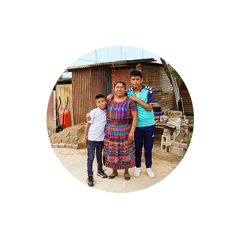 a woman hugging two boys in their house