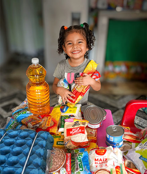 a little girl with food supplies