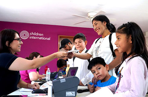 a woman with her family receiving a gift
