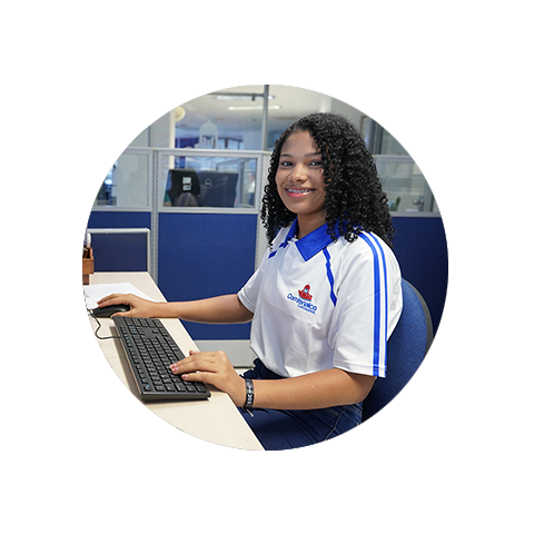 a young woman sitting in front of a computer