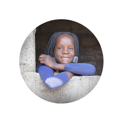 Girl smiles out a window