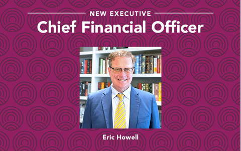 man with coat and tie smiling